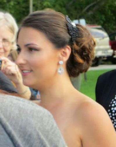Woman with elegant updo and makeup, wedding guest