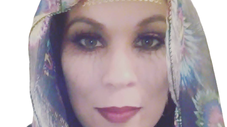 Woman in floral headpiece and veil, dramatic makeup