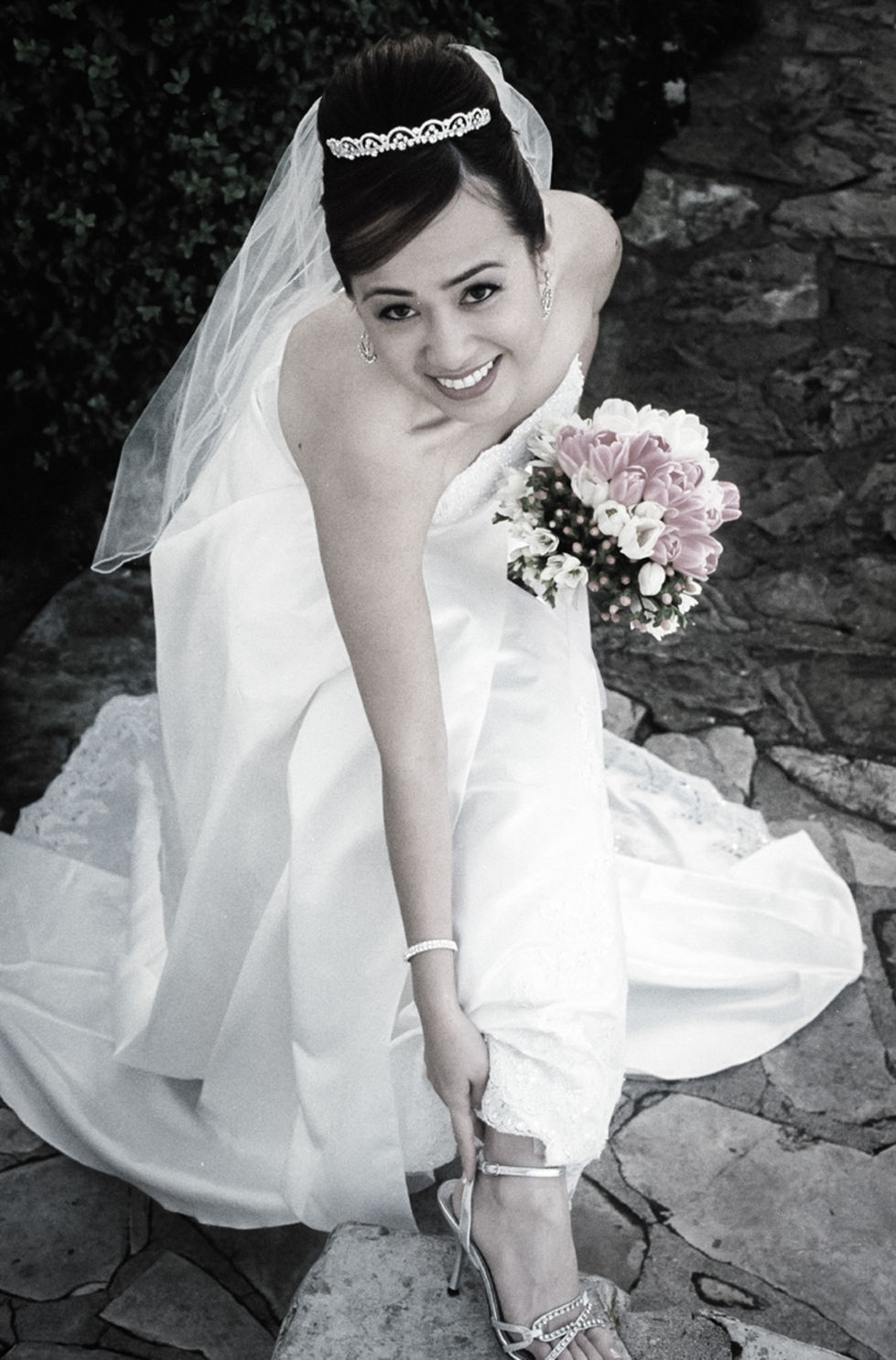 a woman in a wedding dress holds a bouquet of pink and white flowers