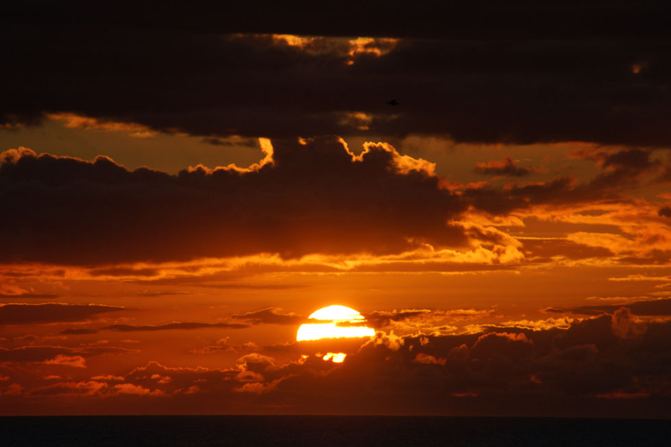 the sun is shining through the clouds at sunset