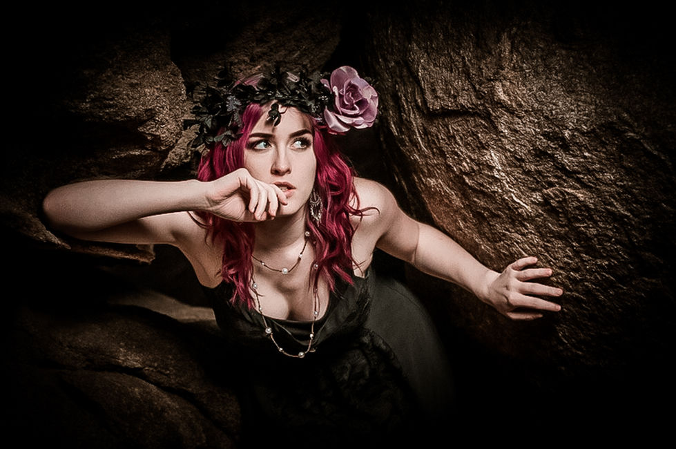 a woman with red hair and a flower in her hair