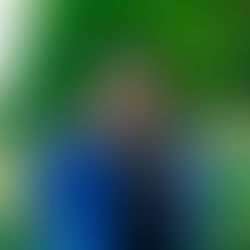 Dr. Angela with the statue of a closed fist, with the Washington Monument in the background