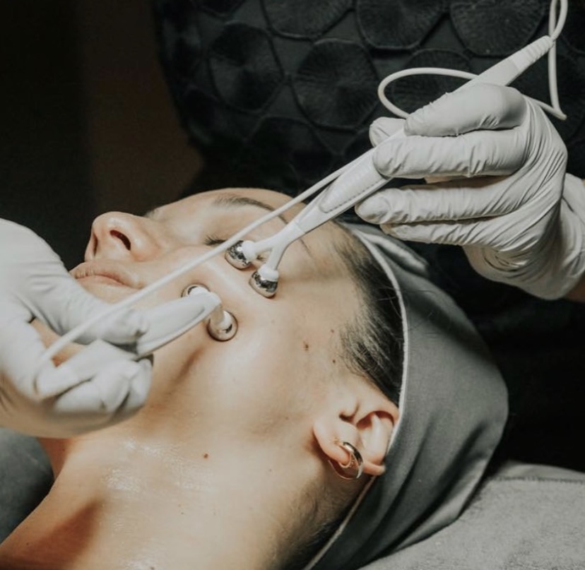 Microcurrent wands lifting and toning along the jawline during a Flawless treatment