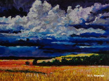 Rolling clouds of thunder move over a field of green trees and yellow grass.