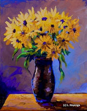 A bright bunch of yellow daises sits in a dark brown vase on a table in a lavender room.