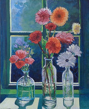 Three clear vases sit on a sunlit window sill with red, orange, pink and white flowers.