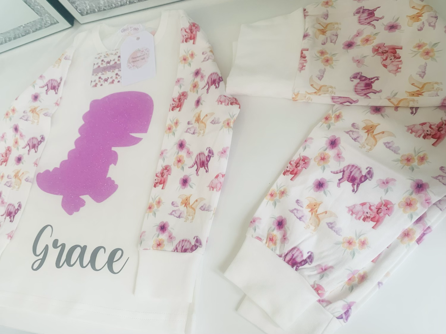 Pink dinosaur pyjamas and romper