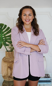 woman in a purple jacket smiling at the camera