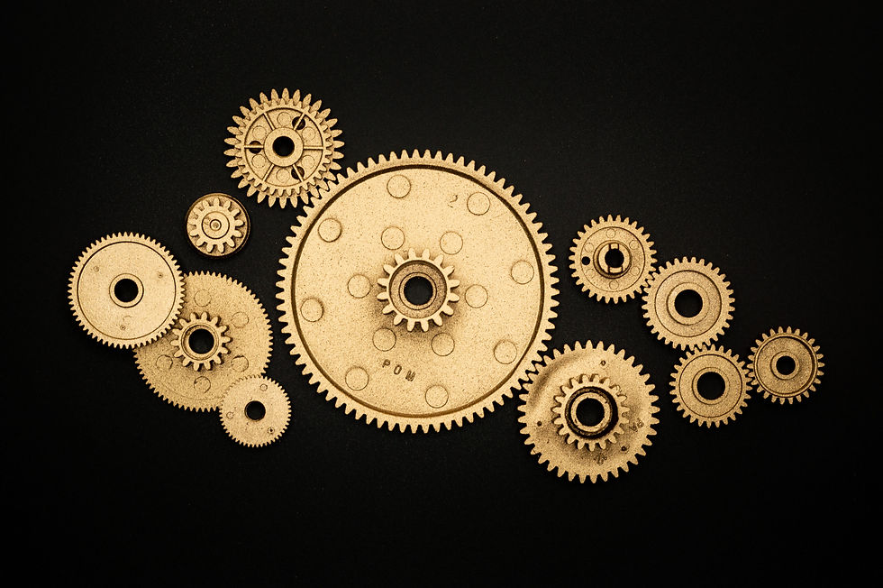 Gold cogs and wheels represent what AI can do for small businesses in 2023.