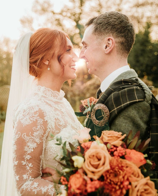 bridal couple with autumnal wedding bouquet