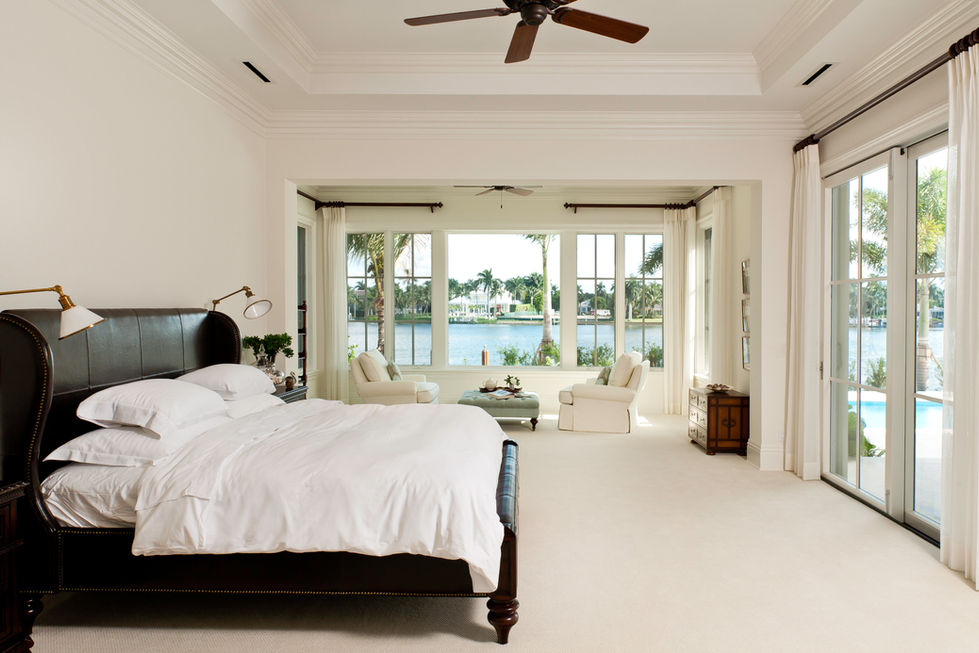 Southwest Florida construction project, interior bedroom of a large home or mansion with large windows, a view of the ocean, and ceiling beams. 