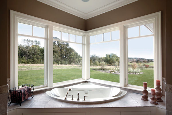Southwest Florida construction project, interior of a large bathroom with jacuzzi tub overlooking the golf course with floor to ceiling windows. 