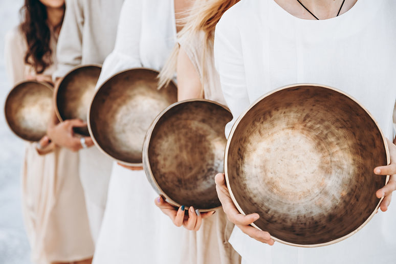 Tibetan singing bowls for meditation in hands. Copy space.jpg