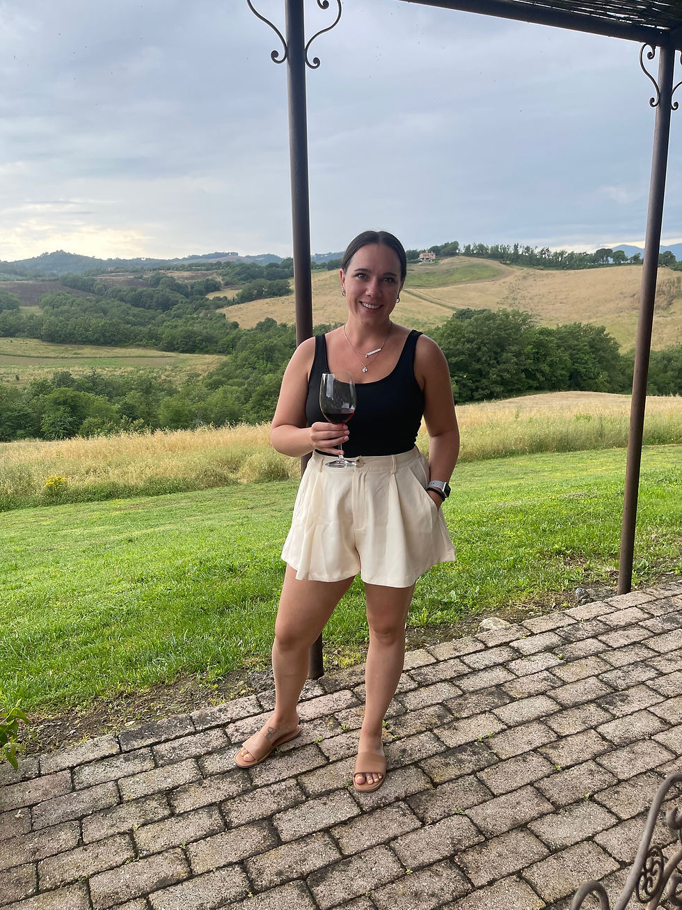 Woman holding a glass of wine in Italy