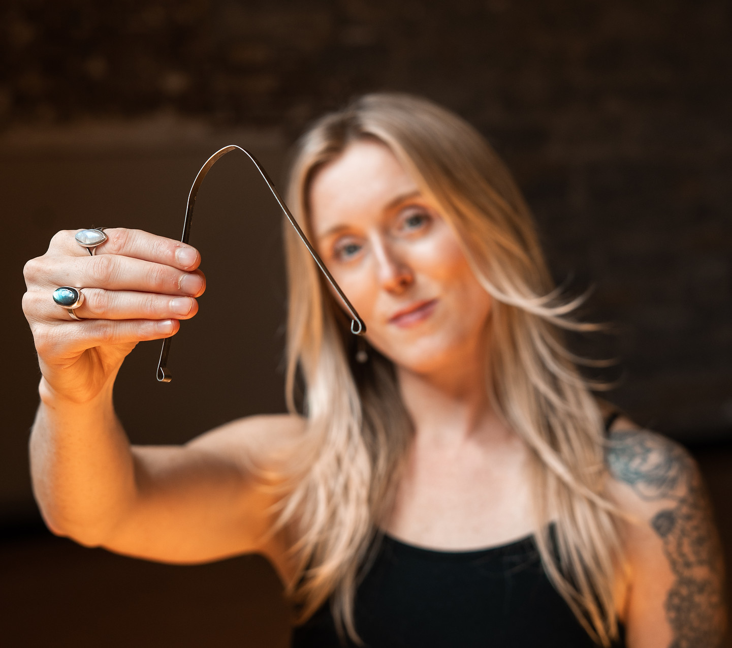 Woman holding tongue scraper. Traditional Chinese Medicine. Wellness routine. 