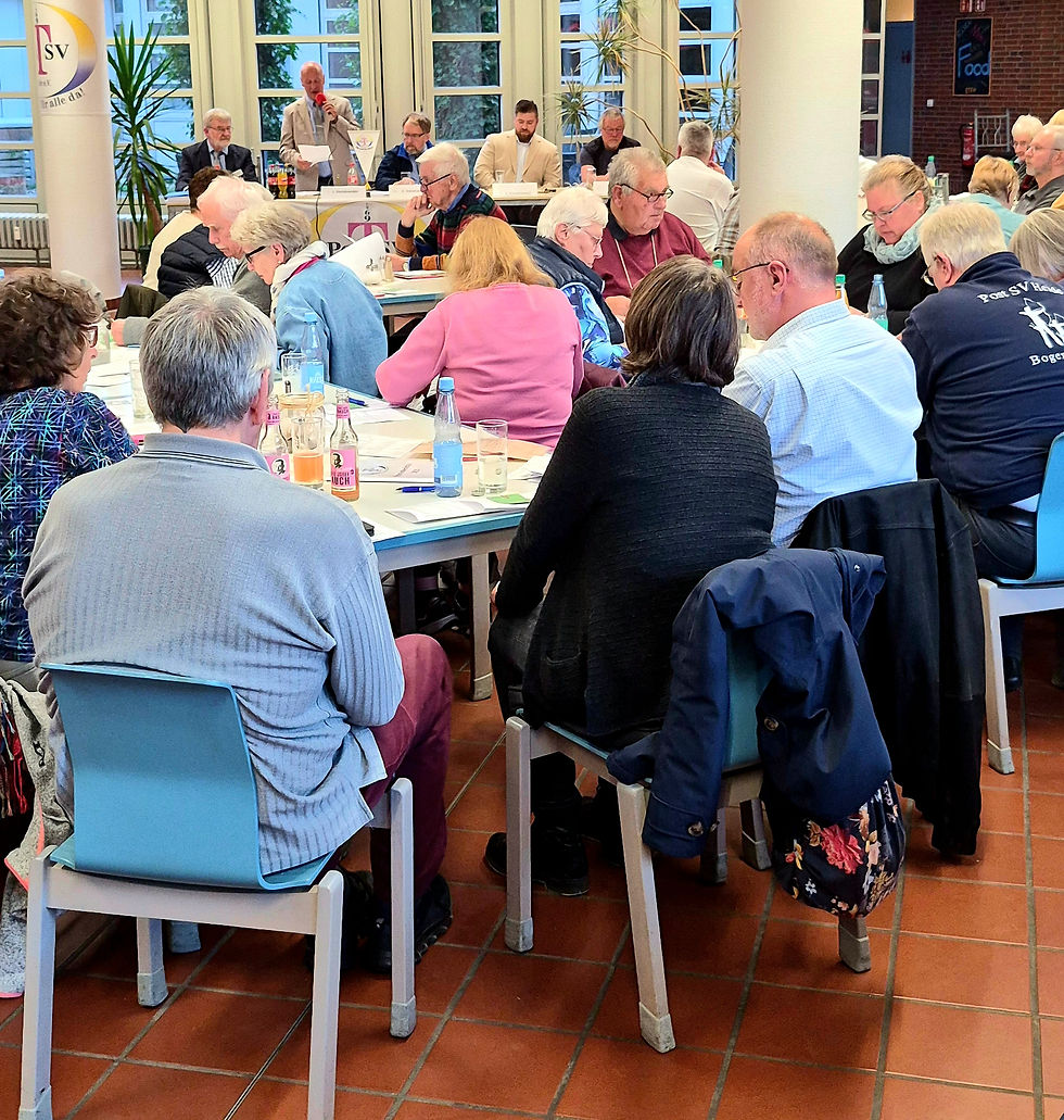 Mitglieder sitzen im Saal bei der Jahreshauptversammlung des Postsportvereins Heide