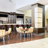 AZ Brew bar with seating area inside a contemporary cafe setting.