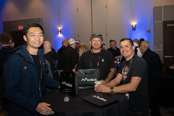 Three men smiling at the camera, Modus bag, KICK-OFF PARTY conference attendees