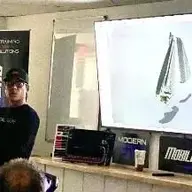 Man presenting, holding object, screen showing design, SMART SOLUTIONS logo, MODERN MOBILE SOLUTION