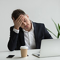 frustrated-millennial-businessman-having-strong-headache-tired-from-laptop-work.jpg