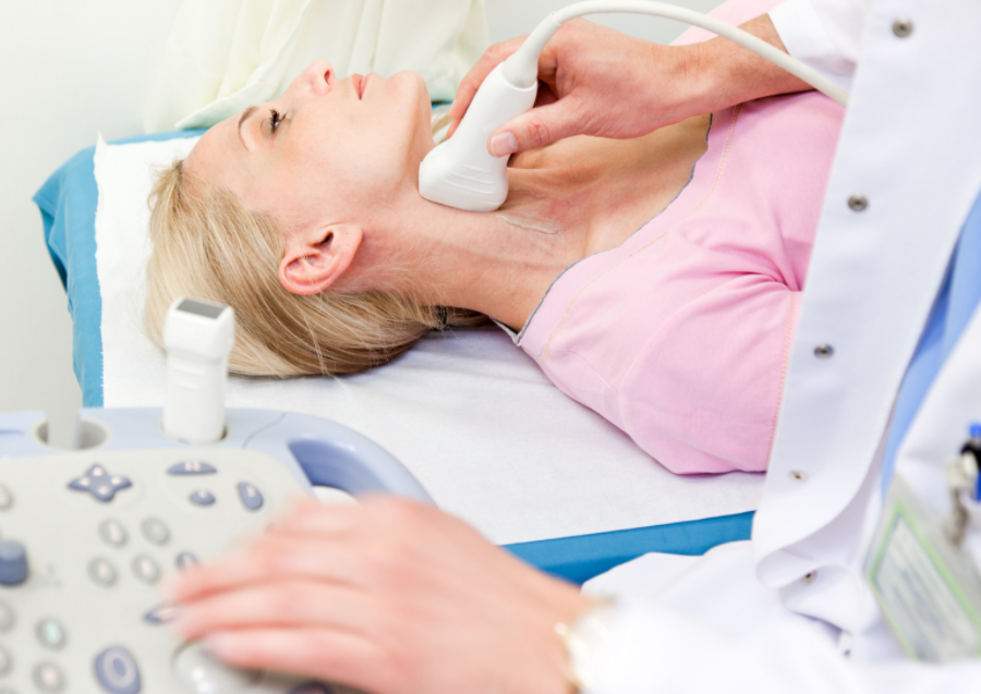 woman holding a book, next to a coffee mug