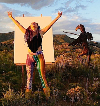 Wendy with arms stretched out towards the sky.
