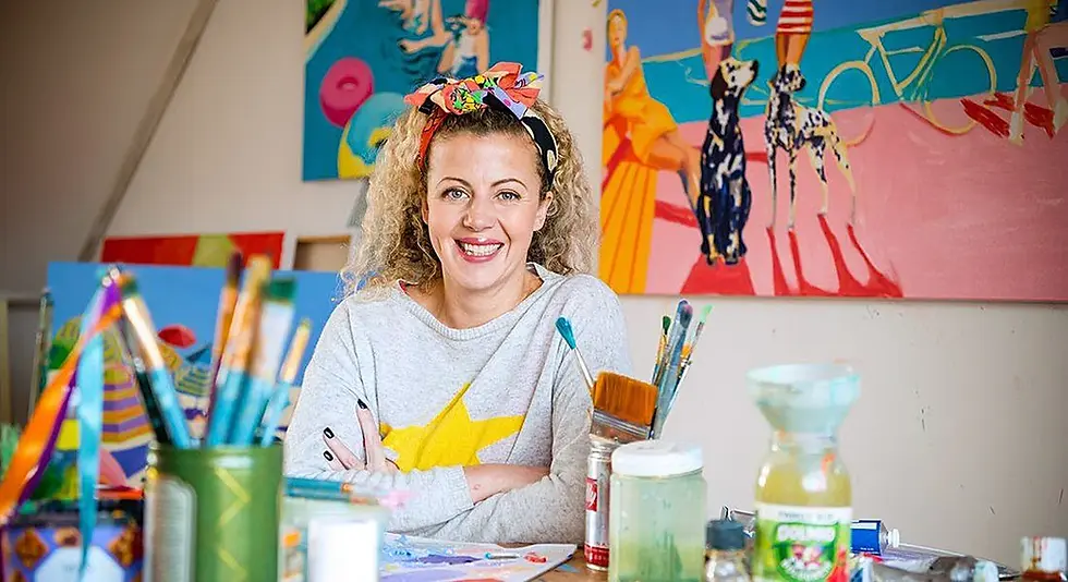 Ruth Mulvie in her Brighton studio surrounded by colorful artwork.
