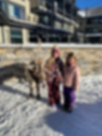 The girls posing next to Xmas reindeer