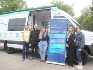 The Mobile Health Team poses in front of their van