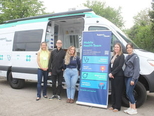 The Mobile Health Team poses in front of their van