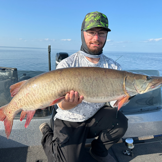 Angler displays a mid summer Mille Lacs muskie catch.