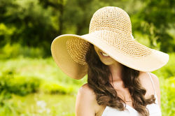 Young smiling woman in summer hat