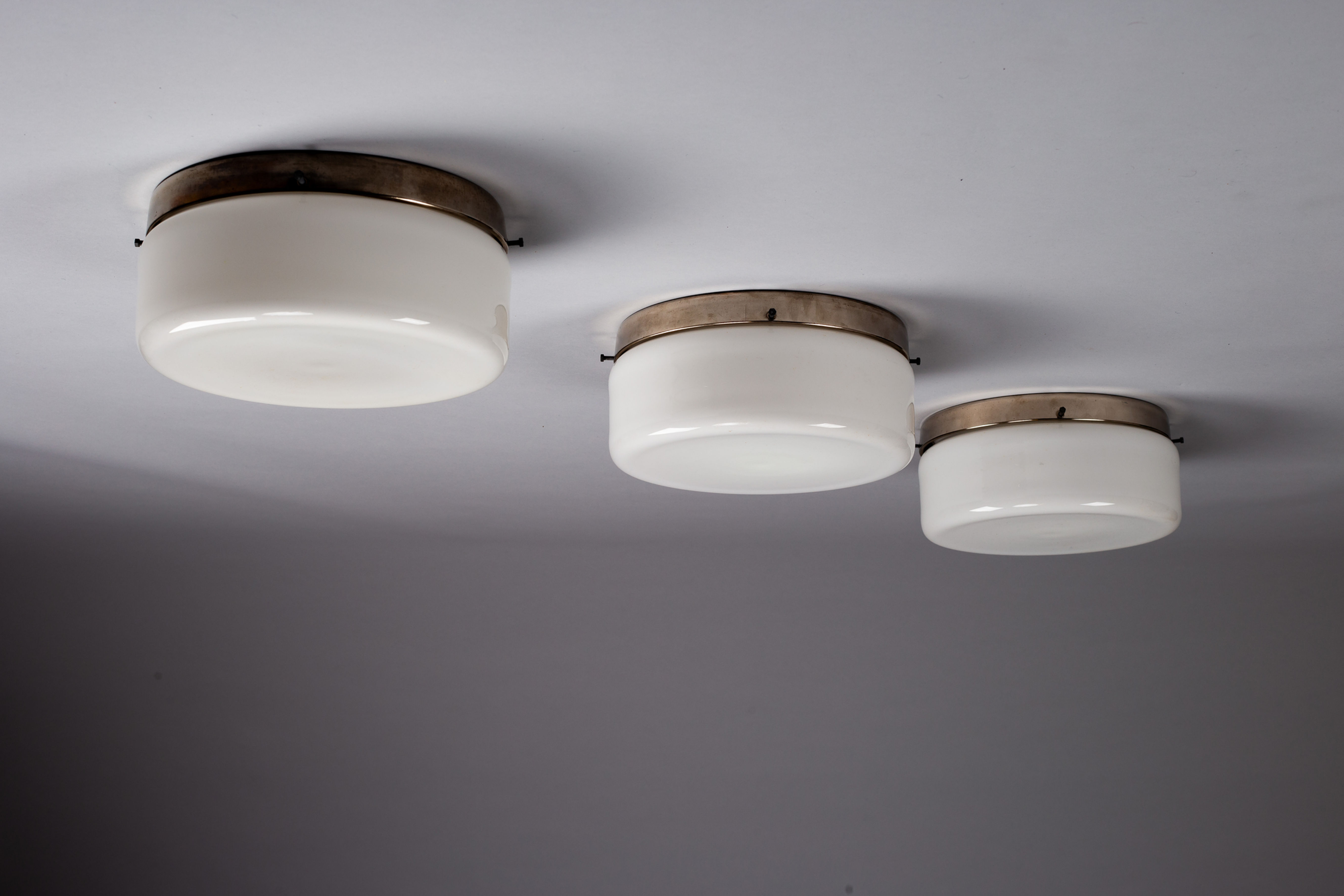 Paavo Tynell, set of three 1930s opaline glass flush mounts, Taito Oy