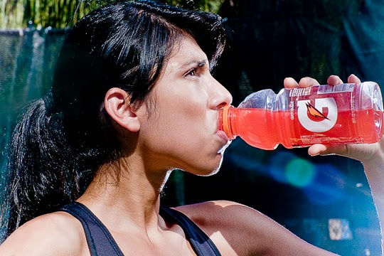 Eye-level view of a runner drinking from a hydration pack during an ultramarathon in a forest trail