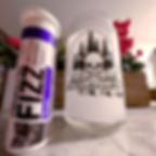 A tube of Fizz sits beside a Pick Your Poison glass