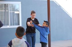 Team member with student Abisaí