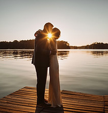a picturesque wedding couple during the sunset on a lake