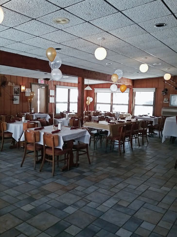 Coffee shop dining area set up for event with decorated tables and balloons