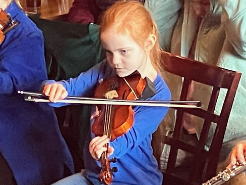 A student playing at a music session.