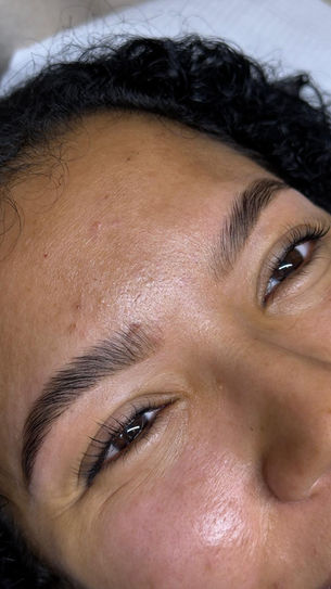 Close-up of defined, shaped and tinted eyebrows.