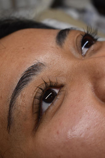 Close-up of defined brow shaping and tint.