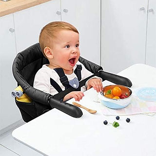 Child in the Surplex Folding Baby Hook on Seat in black up against a table eating a meal