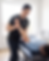 Physical therapist stretching patient's arm on treatment table