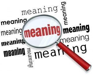 A magnifying glass is focussed on the word "meaning". And yes, focus on meaning is essential to understand your partner.