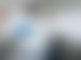 Image of a man in full white ppe and respirator, holding a Fumigation Machine H2O2 Hydrogen Peroxide system (Oxypharm) machine with white gas coming out