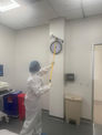 person performing terminal cleaning of a USP clean room