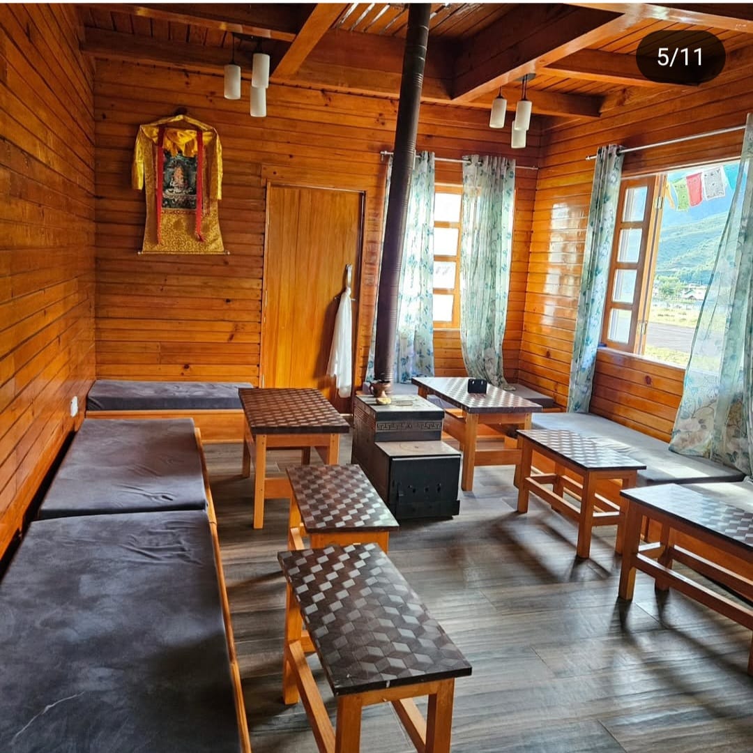 Warm fireplace and common seating area at Khusimsim Mechuka homestay for guest evenings