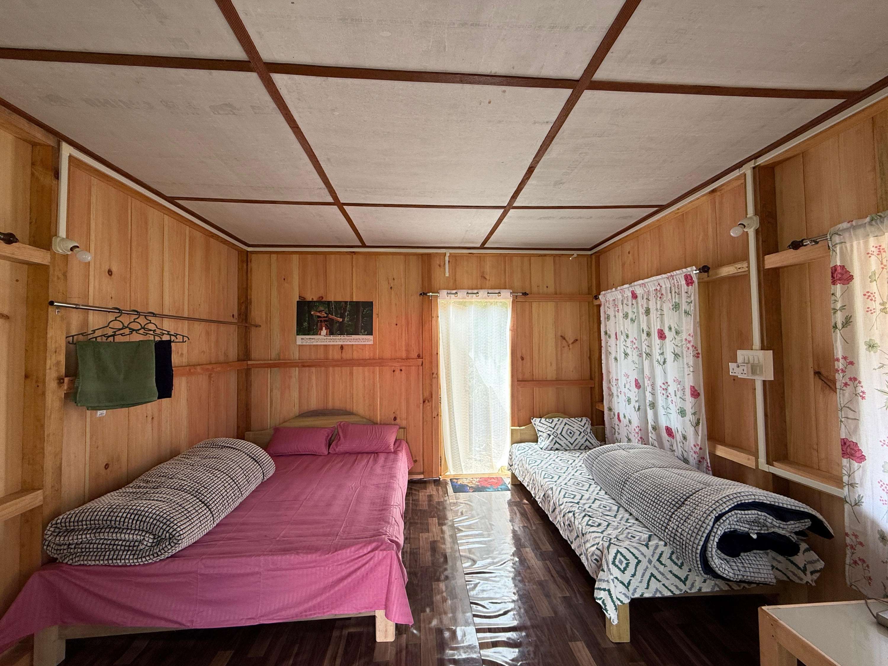 Triple bed room interior at Acheso Homestay Anini showing comfortable accommodation for guests in mountain setting