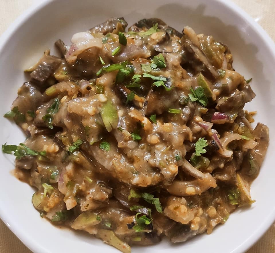 Iromba traditional Manipuri dish with fermented fish, mashed potatoes and green chilies on banana leaf