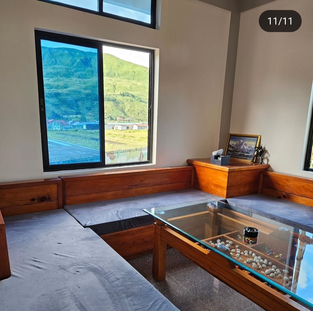 Warm fireplace and common seating area at Khusimsim Mechuka homestay for guest evenings